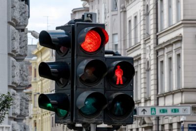 Close-up of traffic light in city. Red light at an intersection.