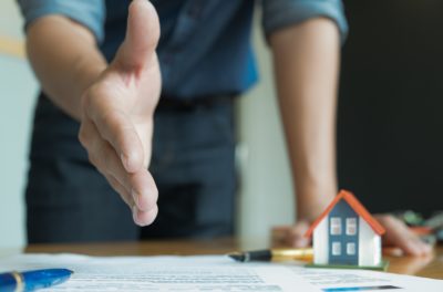 timeshare salesperson extending hand to close the sale based on verbal representations. 