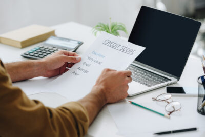 cropped view of man holding credit score in apartment